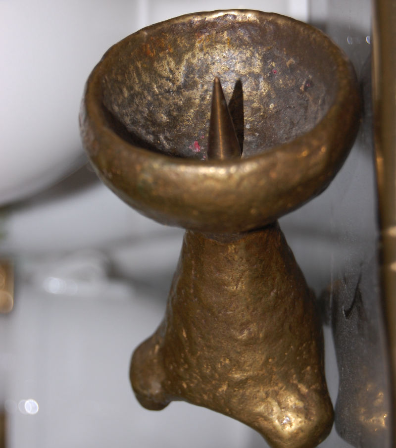 A pair of small brutalist style brass candle holders