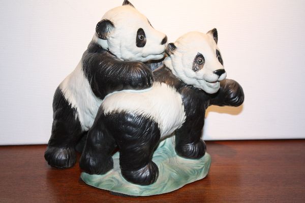 An East-German porcelain figurine of 2 playing young pandas by Karl Ens, Volkstedt