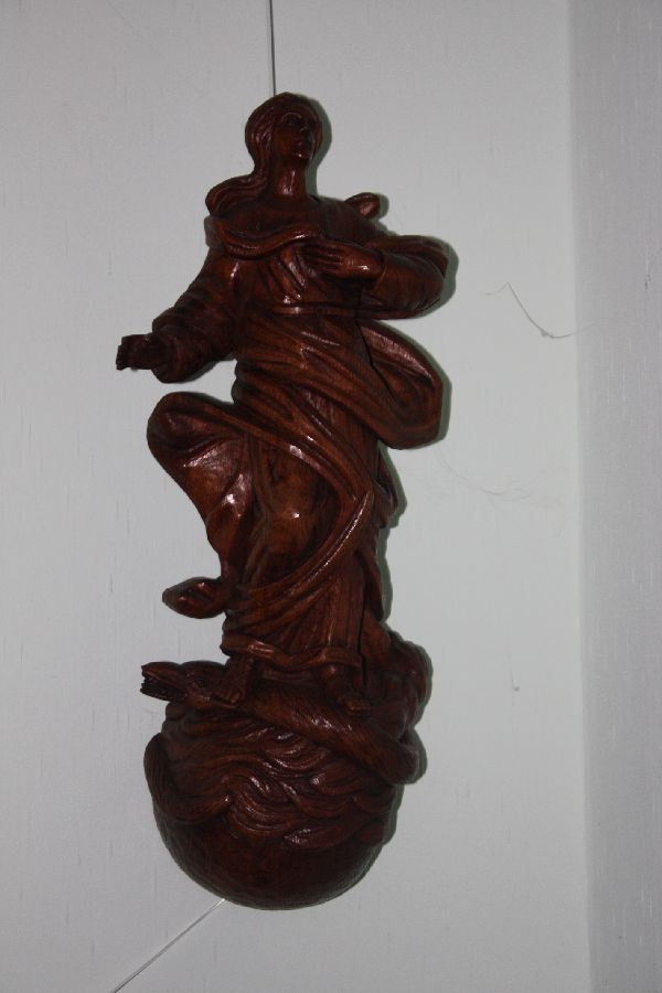 A large 20th century Virgin Mary treading on a snake figure wall statue