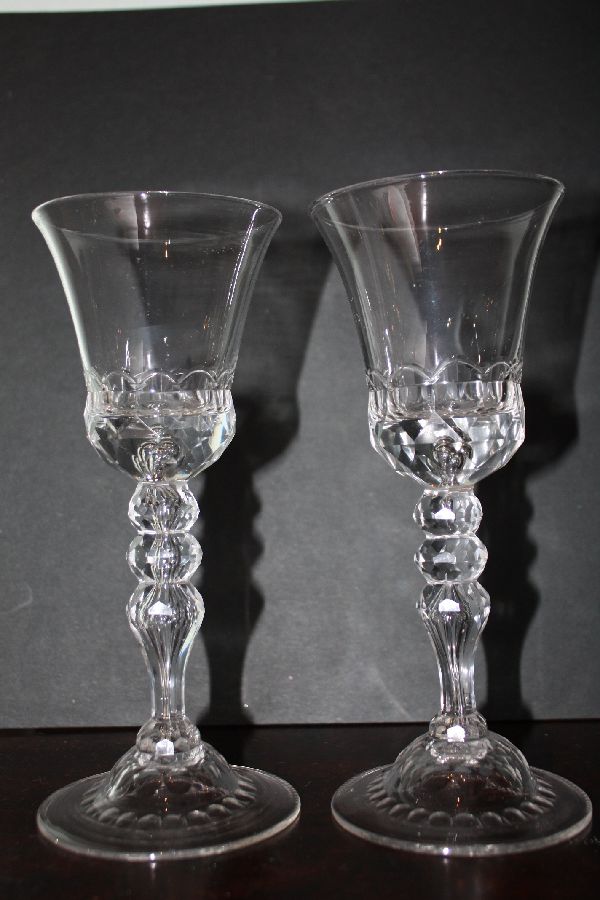 A pair of decorative tall antique 18th century wine glasses